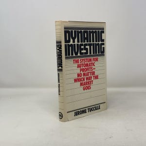 May include: A white book with a red title that reads "Dynamic Investing: The System for Automatic Profits - No Matter Which Way the Market Goes". The author is Jerome Tuccille.
