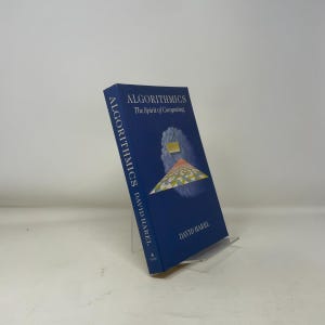 May include: A hardcover book titled "Algorithmics The Spirit of Computing" by David Harel. The book has a dark blue cover with white text and a colorful graphic. The book is displayed on a clear acrylic stand.