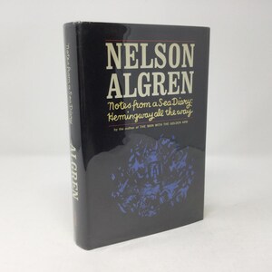 以下が含まれることがあります： 背表紙と表紙に金色の文字が書かれた黒いハードカバーの本。タイトルは「ネルソン・アルグレン：海の航海日誌からのメモ：ヘミングウェイ一直線」で、著者は「黄金の腕を持つ男」の著者です。