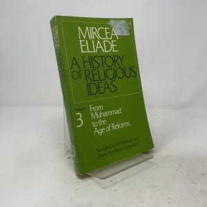 May include: A green paperback book titled A History of Religious Ideas, Volume 3, From Muhammad to the Age of Reforms by Mircea Eliade. The cover features black text on a solid green background with a small white sticker residue at the top.