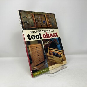 May include: A book titled "Building the Perfect Tool Chest" with a red cover and a picture of a wooden tool chest with drawers. The book includes 15 projects.