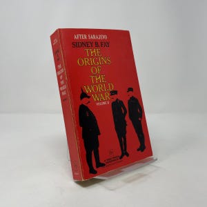 May include: A vintage paperback book titled "The Origins of the World War" by Sidney B. Fay. The book has a red cover with black text and illustrations of soldiers. The book is Volume II and is from the Free Press Paperback series.
