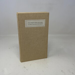 May include: A beige hardcover book with the title "OLD FRIEND FROM FAR AWAY" on a white label. The label also includes "150 Chinese Poems from the Great Dynasties". The book has a rectangular shape and a textured cover.