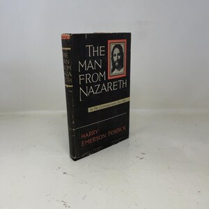 May include: A vintage hardcover book, "The Man From Nazareth" by Harry Emerson Fosdick. The black cover features white text and a portrait within a red border. The book's spine also displays the title.