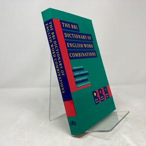 May include: A green hardcover book titled "The BBI Dictionary of English Word Combinations". The book has a red spine with the letters "BBI" in blue on the front cover.