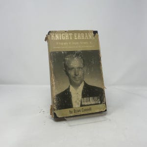 May include: Vintage book titled "Knight Errant" by Brian Connell, a biography of Douglas Fairbanks Jr. The cover features a black and white portrait of Fairbanks in a suit. The book has a worn, aged appearance.