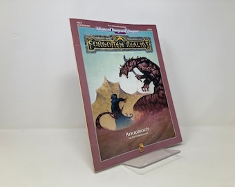 May include: A book cover for the Forgotten Realms campaign setting for the Advanced Dungeons & Dragons role-playing game. The cover features a fantasy illustration of a humanoid figure fighting a large, tiger-like creature. The title "Forgotten Realms" is printed in gold lettering on a black background. The book is titled "Anauroch" by Ed Greenwood.