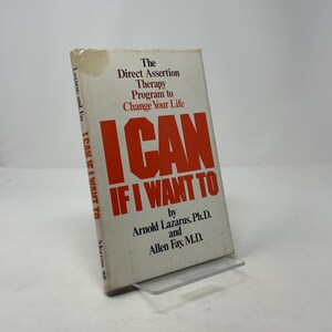 May include: A hardcover book titled "I Can If I Want To" by Arnold Lazarus and Allen Fay. The book's cover features the title in large red letters, with the subtitle "The Direct Assertion Therapy Program to Change Your Life."