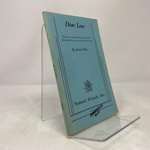 May include: A blue book titled "Dear Love" by Jerome Kilty. The book is based on certain poems and letters of Elizabeth Barrett Browning and Robert Browning. The book is published by Samuel French, Inc.