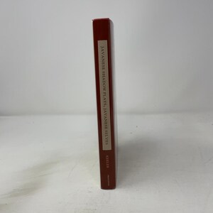 May include: A dark red book spine standing upright. The title JAVANESE SHADOW PLAYS, JAVANESE SELVES is printed in black text on a light tan rectangular background. The author name KEELER and the publisher PRINCETON are printed below the title.