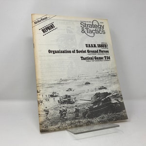 May include: A magazine cover for Strategy & Tactics, issue number 23, dated June-Oct 1979. The cover features a black and white photo of Soviet tanks and soldiers in a field. The text on the cover reads "U.S.S.R. ISSUE! Organization of Soviet Ground Forces EASTFRONT ANALYSIS, Part 1 Tactical Game: T34 TABLE TOP ARMORED COMBAT"