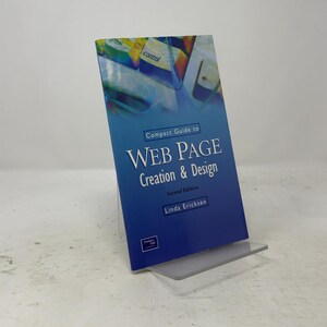 May include: A softcover book titled Compact Guide to Web Page Creation & Design, Second Edition by Linda Ericksen. The cover features a blue gradient background with a graphic of computer keyboard keys at the top and the Prentice Hall logo.