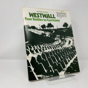 May include: A black and white photo of a magazine cover featuring the text "Westwall Four Battles to Germany" and a photo of a concrete wall with a row of trees in the background. The magazine is titled "Strategy & Tactics".