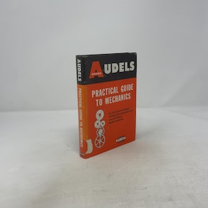 May include: A vintage book titled "Audels Modern Practical Guide to Mechanics." The book has a black and orange cover with white text. The spine also has the title in white. The book features illustrations of gears.