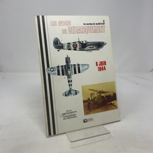 May include: A book titled "LES AVIONS DU DEBARQUEMENT" featuring illustrations of vintage airplanes. The cover includes the text "6 JUIN 1944" and the names Gaston Botquin and Gill Van Dessel. The book has a white background with black and gray stripes.