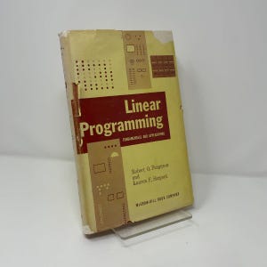 May include: A hardcover book titled Linear Programming: Fundamentals and Applications by Robert O. Ferguson and Lauren F. Sargent, published by McGraw-Hill Book Company. The cover is yellow with a red central rectangle and geometric patterns.