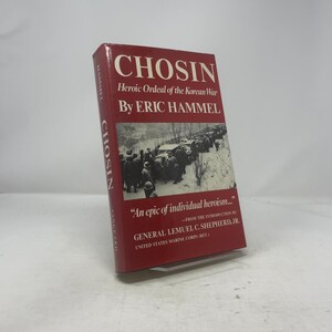 May include: A hardcover book titled "CHOSIN" by Eric Hammel. The cover is red with white text and a black and white image of soldiers in a snowy landscape. The book is about the Korean War.