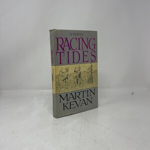 May include: A copy of the novel "Racing Tides" by Martin Kevan. The book's cover is grey with the title in large, purple letters. The spine displays "Racing" vertically. The cover features an illustration of figures with spears.