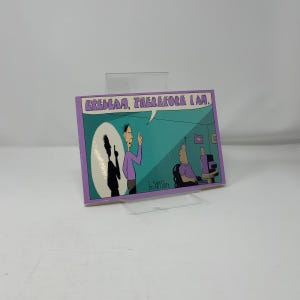 May include: A rectangular cartoon print with a purple border. The print features a comic scene with two figures, one in a purple shirt and the other at a computer. Text at the top reads "Erebeam, Therefore I Am."