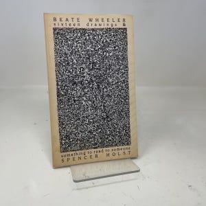 May include: A book titled "BEATE WHEELER sixteen drawings & something to read to someone SPENCER HOLST". The cover features a black and white speckled design with text in black and a tan border.