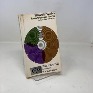 May include: A vintage paperback book titled "William O. Douglas the anatomy of liberty" with a colorful circular design on the cover. The book is part of the "Credo Perspectives" series.