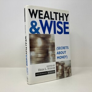 May include: A white book with the title "Wealthy & Wise (Secrets About Money)" in black and blue text. The book cover features a stack of silver coins.