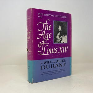 May include: A purple hardcover book titled "The Age of Louis XIV" by Will and Ariel Durant. The book is part of "The Story of Civilization" series and is volume VIII.