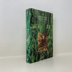 May include: A book cover with a green background featuring a photo of a man in a forest. The title of the book is "W.H. Hudson A Biography" by  R.  T.  Norman.