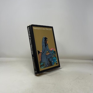 May include: A hardcover book titled "Rubaiyat of Omar Khayyam" with a gold and black cover. The cover features an illustration of a figure in a blue robe. The book's spine also displays the title and author's name.