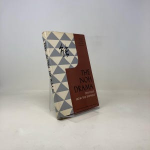 May include: A book titled "The Noh Drama: Ten Plays from the Japanese" with a gray and white geometric pattern on the cover. The title is in red and white text.