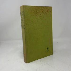 May include: A hardcover book with a light green cover featuring a subtle orange speckled pattern. The spine displays the text From Primitives to Zen by Mircea Eliade. A small green logo with the number 1817 is printed on the bottom right corner.