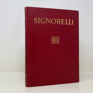 May include: A red hardcover book with the title "Signorelli" in gold lettering. The book is part of a series called "Klassiker DVA Der Kunst" and has a gold embossed logo on the front cover.