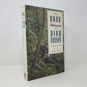 May include: Book cover with a photo of a person in a jungle setting. The title is "The Dark Romance of Dian Fossey" by Harold T.P. Hayes.