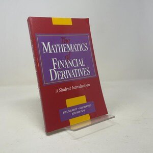 May include: A hardcover book titled The Mathematics of Financial Derivatives: A Student Introduction by Paul Wilmott, Sam Howison, and Jeff Dewynne. The cover is red with a purple rectangular center, yellow accents, and white text.