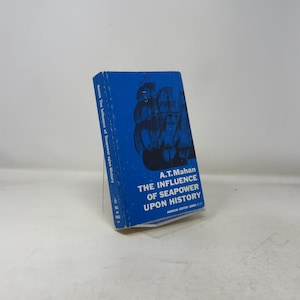 May include: A.T. Mahan's "The Influence of Seapower Upon History" book. The cover is blue with a ship illustration and white text. The book is part of the American Century Series.