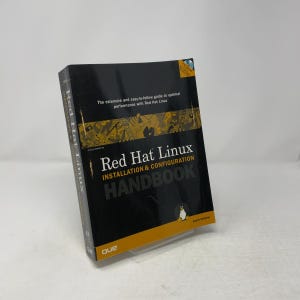 May include: A black and yellow technical book titled Red Hat Linux Installation & Configuration Handbook. The cover features a small penguin graphic, the Que logo, and text stating it is an extensive and easy-to-follow guide to optimal performance.