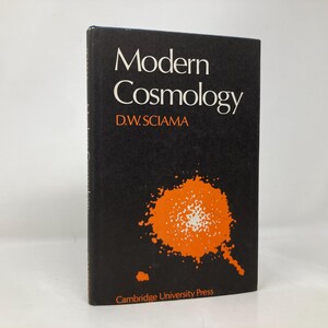 Puede incluir: Un libro negro con el título "Modern Cosmology" de D.W. Sciama. La portada del libro presenta una ilustración naranja y blanca de una nebulosa.