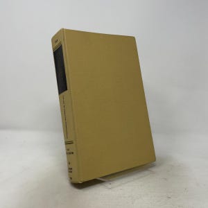 May include: A hardback book titled The Art of Computer Programming Vol. 2 Seminumerical Algorithms by Donald E. Knuth. The book features a solid tan cloth cover and a black spine panel with white text detailing the volume and edition information.