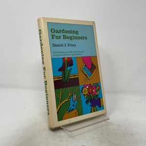 May include: A hardcover book titled Gardening For Beginners by Daniel J. Foley. The cover features a light blue background with four colorful illustrations depicting gardening tasks, including planting, sowing seeds, pruning branches, and holding flowers.