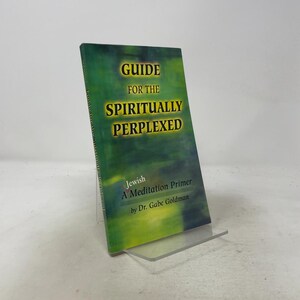 May include: A paperback book titled Guide for the Spiritually Perplexed: Jewish A Meditation Primer by Dr. Gabe Goldman. The cover features a gradient background transitioning from dark green to yellow with bold black text for the main title.