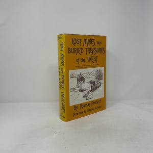 May include: A yellow hardcover book with the title "LOST MINES and BURIED TREASURES of the WEST". The cover features a black and white illustration of a desert scene. The author's name is Thomas Probert.