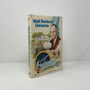 May include: A vintage book titled "Walt Behlen's Universe" with a portrait of a man on the cover. The cover features illustrations of a farm, a telescope, and other scientific imagery. The book's spine displays the title vertically.