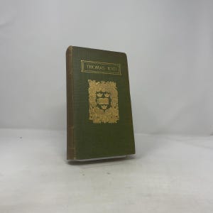 Può includere: Un libro d'epoca con copertina verde e scritte dorate. Il titolo "THOMAS KYD" è in alto e un emblema dorato è centrato sulla copertina. Il libro ha un aspetto usurato, suggerendo che si tratta di un'antichità o di un'edizione molto amata.