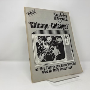May include: A vintage magazine cover for Strategy & Tactics, a game magazine. The cover features a black and white image of a television with a cracked screen. The text on the cover reads 'Chicago-Chicago!' and 'or: "Mrs. O'Leary's Cow, Where Were You When We Really Needed You?"