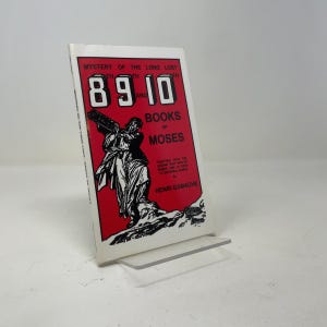 May include: A paperback book titled Mystery of the Long Lost 8, 9 and 10 Books of Moses by Henri Gamache. The cover features a red background with black text and a black and white illustration of a figure holding a stone tablet on a rocky terrain.