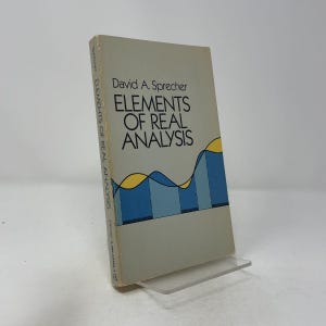 Könnte beinhalten: Ein Taschenbuch mit dem Titel Elements of Real Analysis von David A. Sprecher. Der Einband ist hellgrau und zeigt ein grafisches Design mit blauen und gelben Wellenmustern. Der Buchrücken enthält den Autorennamen, den Titel und das Dover-Logo.