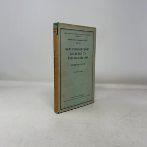 May include: A vintage book titled "New Introductory Lectures on Psycho-Analysis" by Sigmund Freud. The book has a light green and beige cover with text in black. The spine reads "New Introductory Lectures".