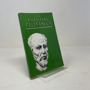 May include: A green paperback book titled The Essential Plotinus with a white line drawing of a bearded man's face on the cover. The text reads The Essential Plotinus and New Translation by Elmer O'Brien. The book is standing upright.