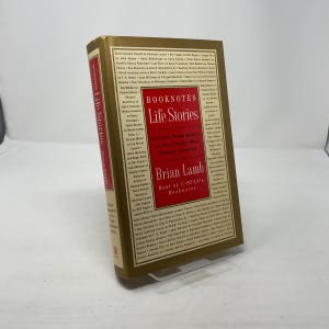May include: A hardback book titled "Booknotes Life Stories" by Brian Lamb. The book has a gold cover with red and white text. The book's spine also displays the title and author.