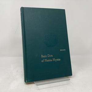 May include: A dark green hardcover book with the title "Basic Data of Plasma Physics" and the author's name "Brown" printed in gold lettering.